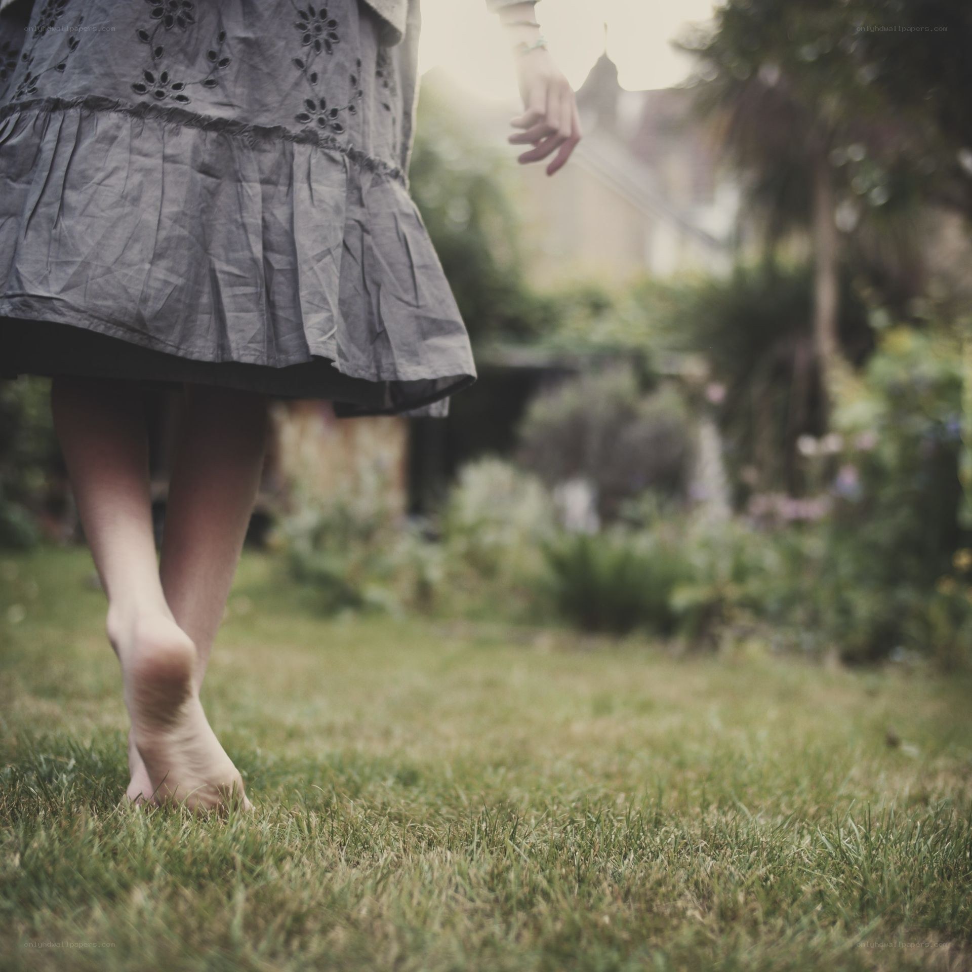 person walking barefoot on grass