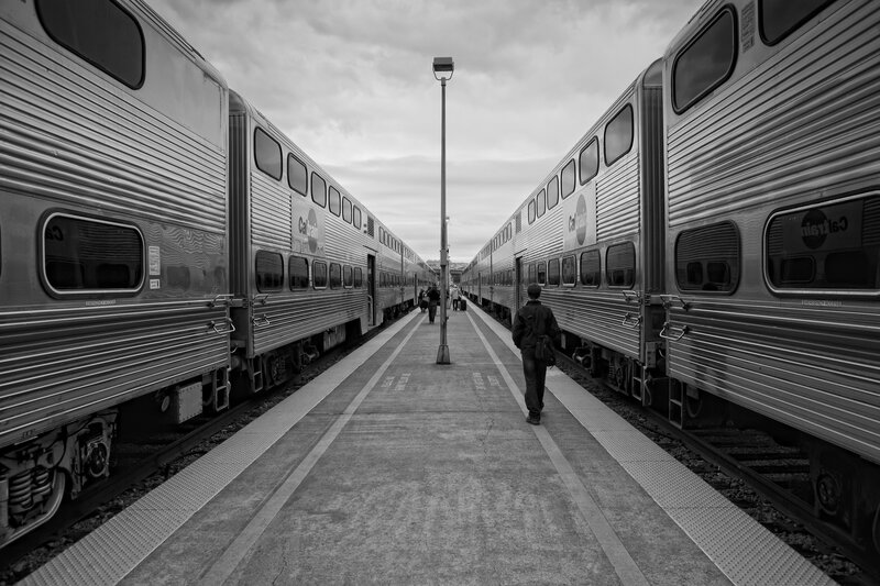 Person walking between two trains