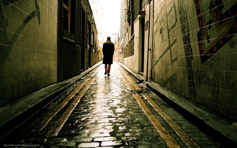 person walking down alley
