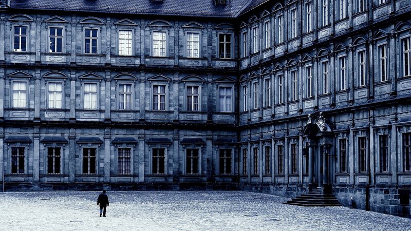Person Walking in Courtyard