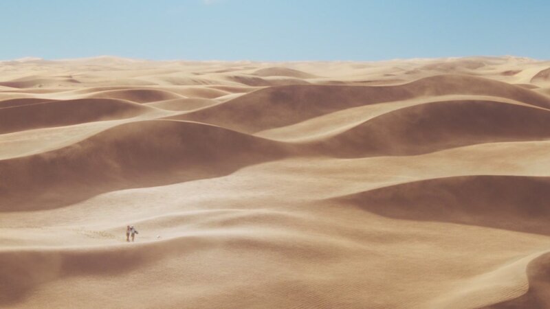 person walking in desert