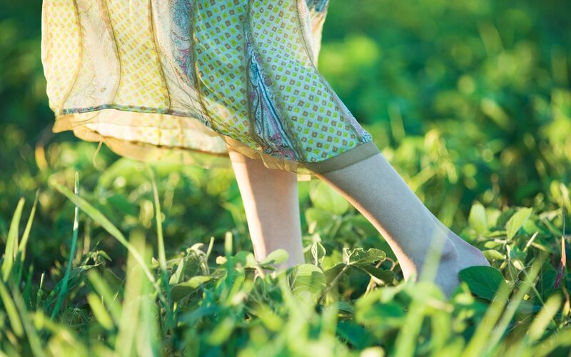 person walking in grass
