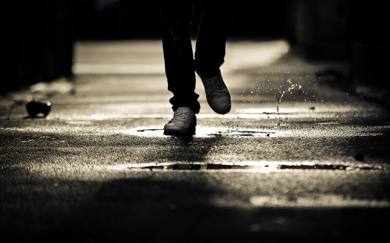 person walking in puddle