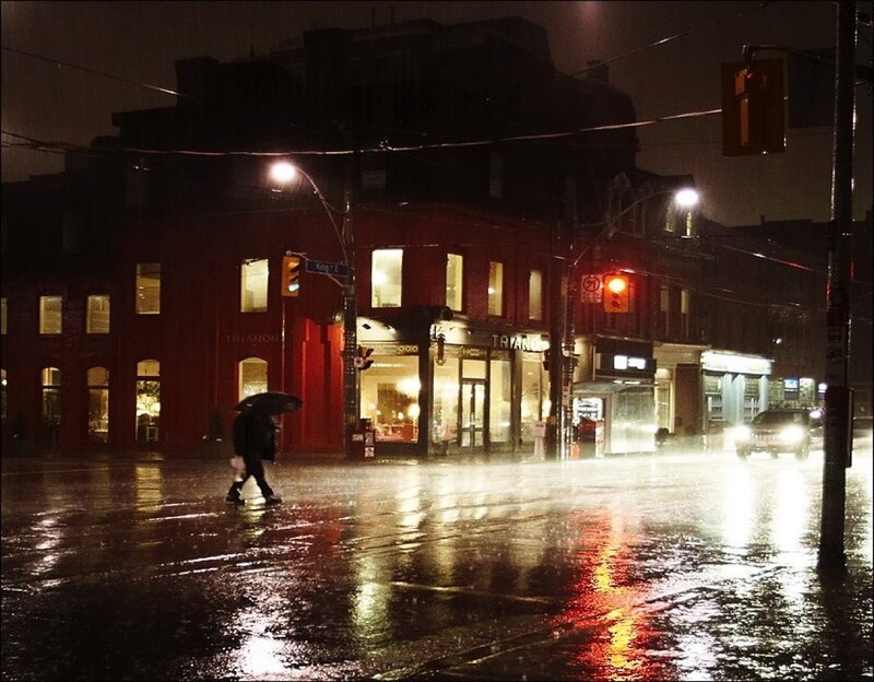 Person walking in rain at night