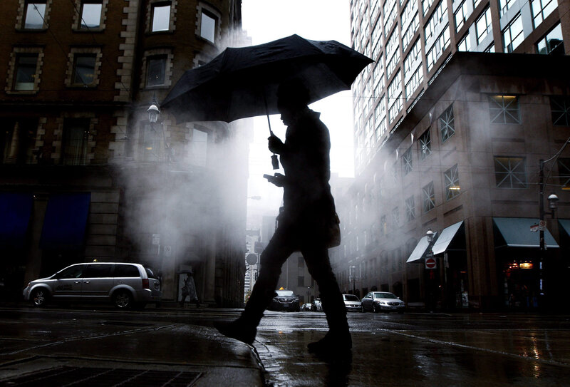 Person walking in rainy city