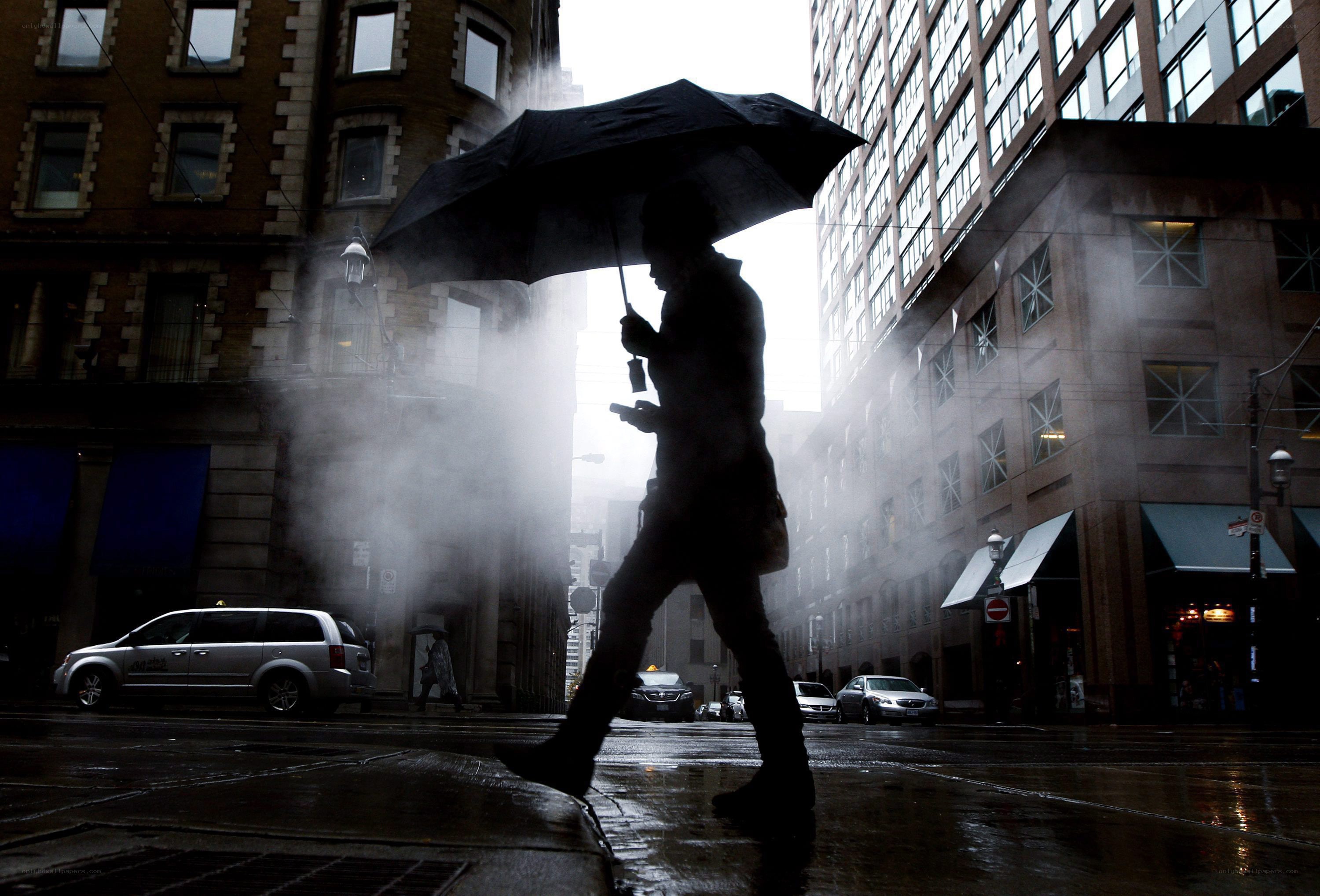 Person walking in rainy city