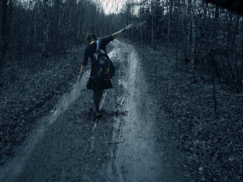 person walking in rainy forest