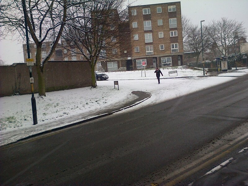 Person Walking in Snow — Gray