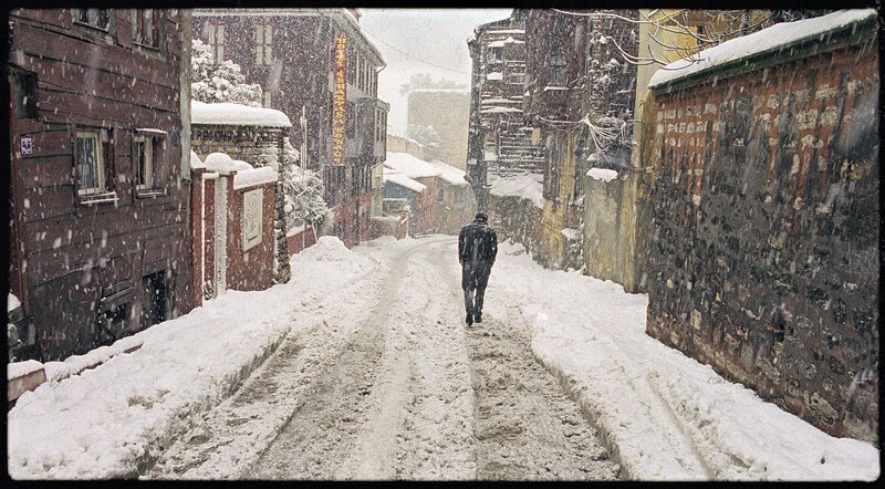 person walking in snowy alley