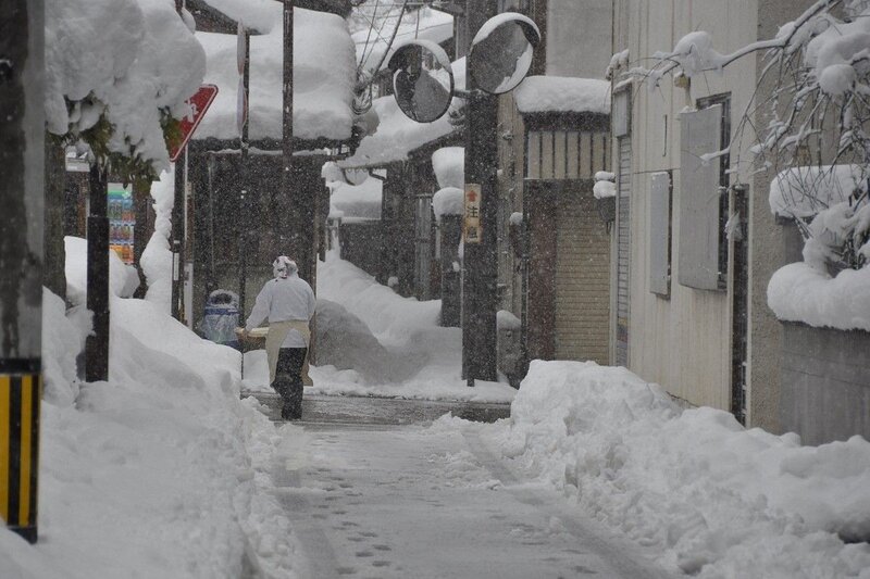 Person walking in snowy alley