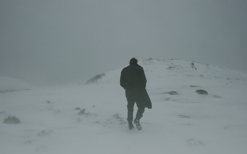 person walking in snowy landscape