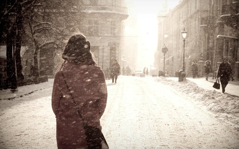 person walking in snowy street
