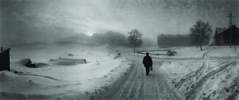 Person walking in snowy village
