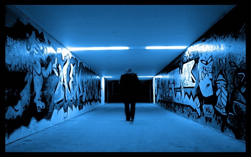 Person Walking in Tunnel
