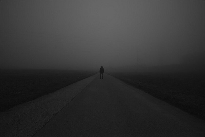Person walking on a foggy road