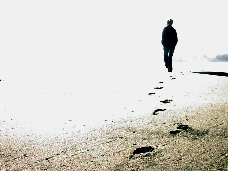 person walking on beach