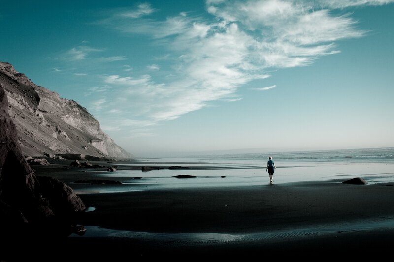 Person Walking on Beach — Blue, Serene, Afternoon, Photograph, Cliff, Ocean