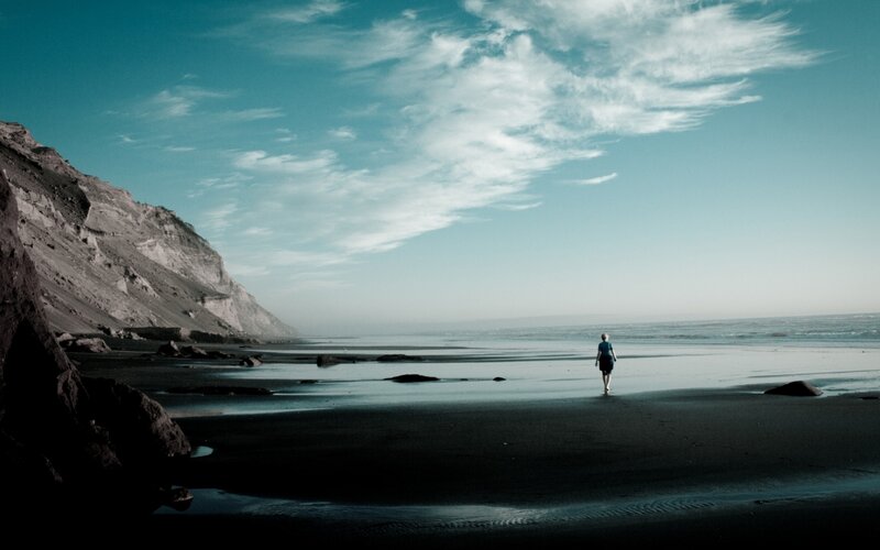 Person Walking on Beach — Blue, Serene, Afternoon, Photograph, Cliff
