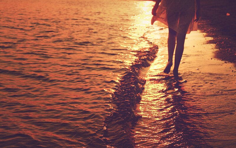 Person Walking on Beach — Orange, Serene, Sunset, Photograph, Ocean, Footprints