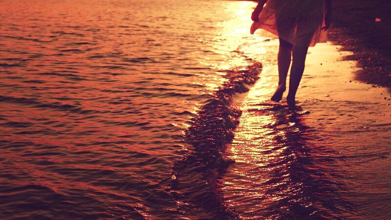 Person Walking on Beach — Red