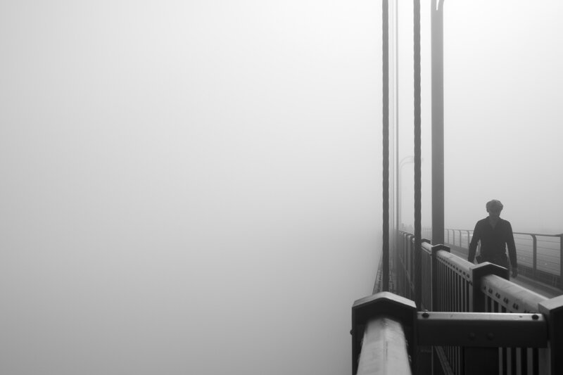 Person Walking on Bridge — Black, Misty