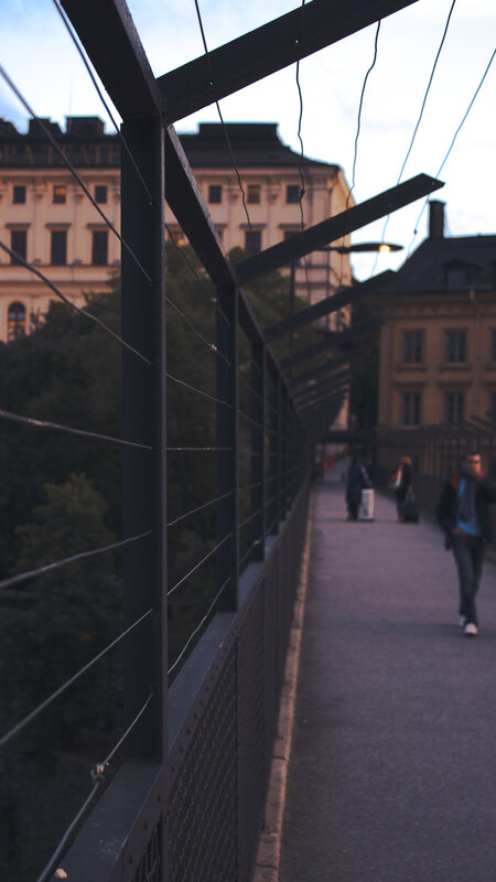 Person Walking on Bridge — Gray, Calm