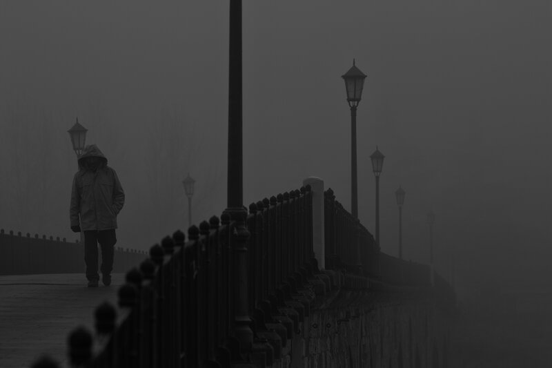 Person Walking on Bridge — Gray, Somber