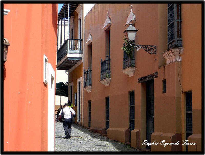 Person Walking on Cobblestone Street — Orange