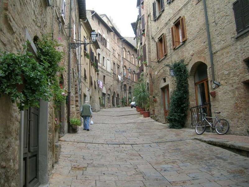 Person Walking on Cobblestone Street