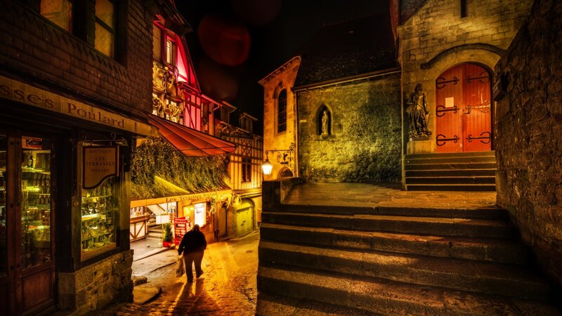 Person Walking on Cobblestone Street — Yellow