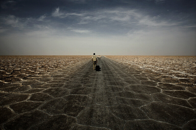 Person Walking on Cracked Ground