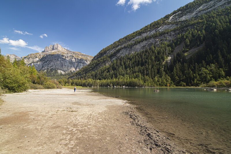 Person Walking on Lake Shore