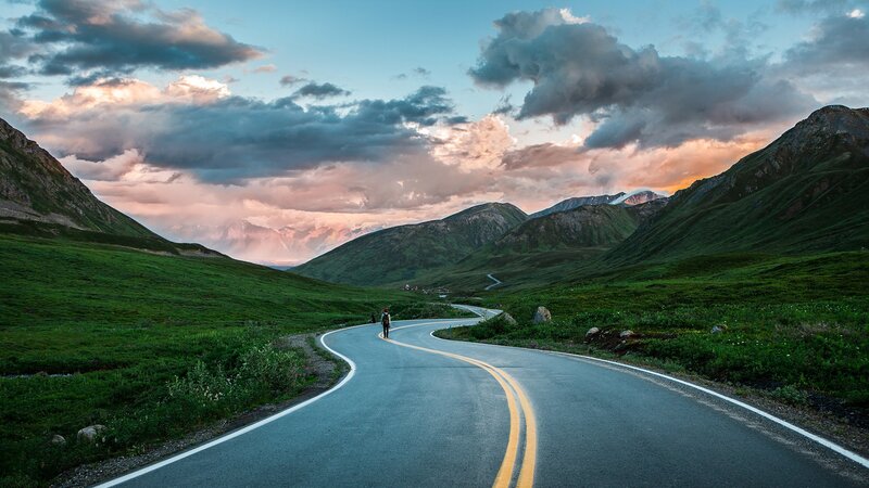 Person Walking on Road — Green, Dramatic, Sunset