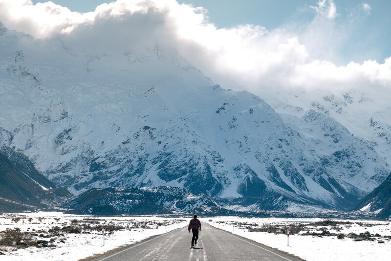 Person Walking on Road — White, Dramatic