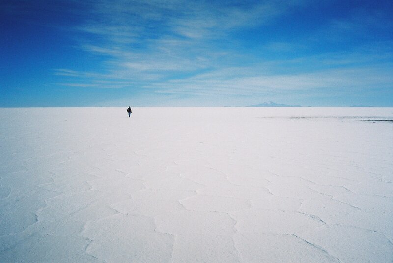Person Walking on Salt Flat — Blue, Serene, Afternoon