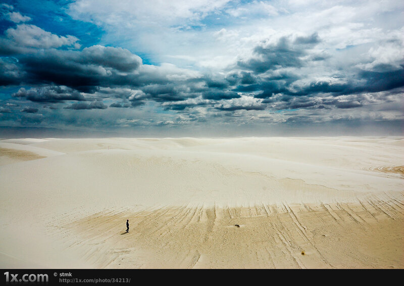 Person walking on sand dunes