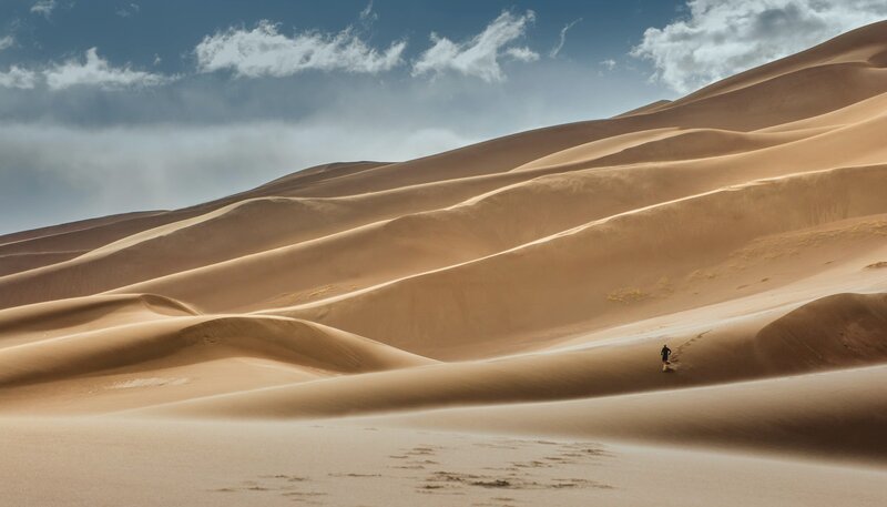 Person Walking on Sand Dunes — Brown