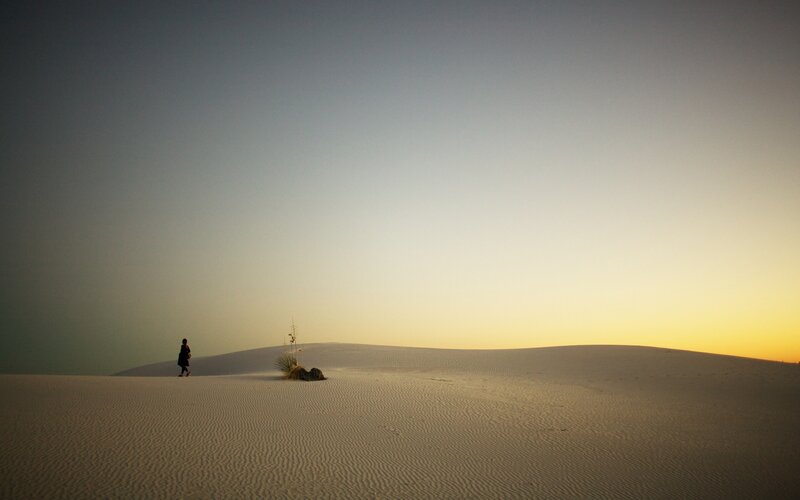 Person walking on sand dunes