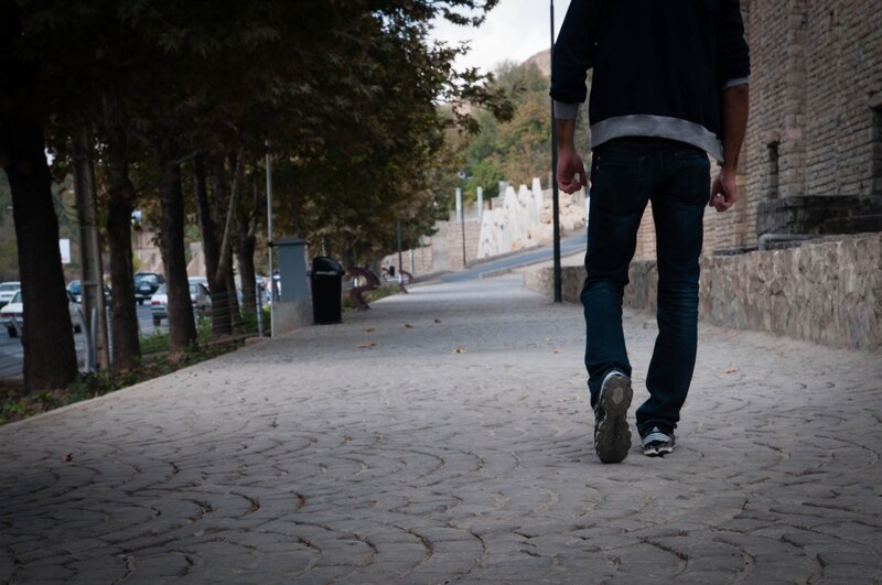 Person Walking on Sidewalk — Gray, Calm