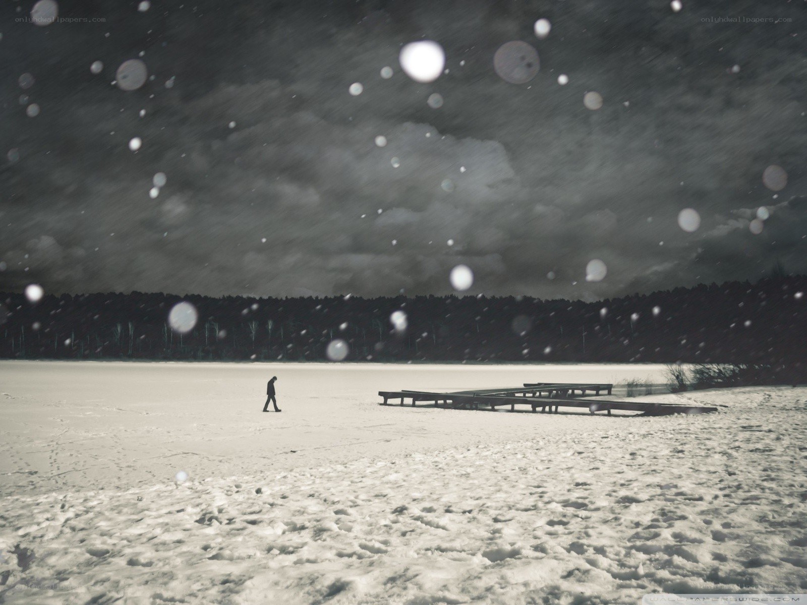 Person walking on snowy lake