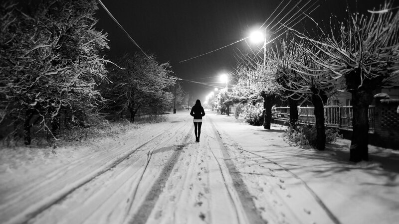 Person Walking on Snowy Road — Black