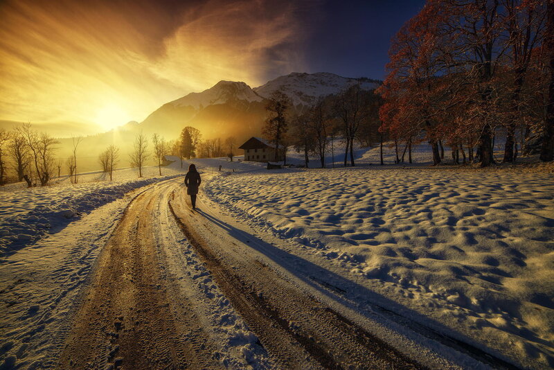 Person Walking on Snowy Road — Gold