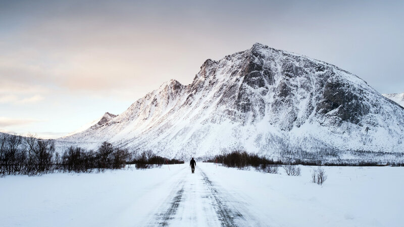 Person Walking on Snowy Road — White