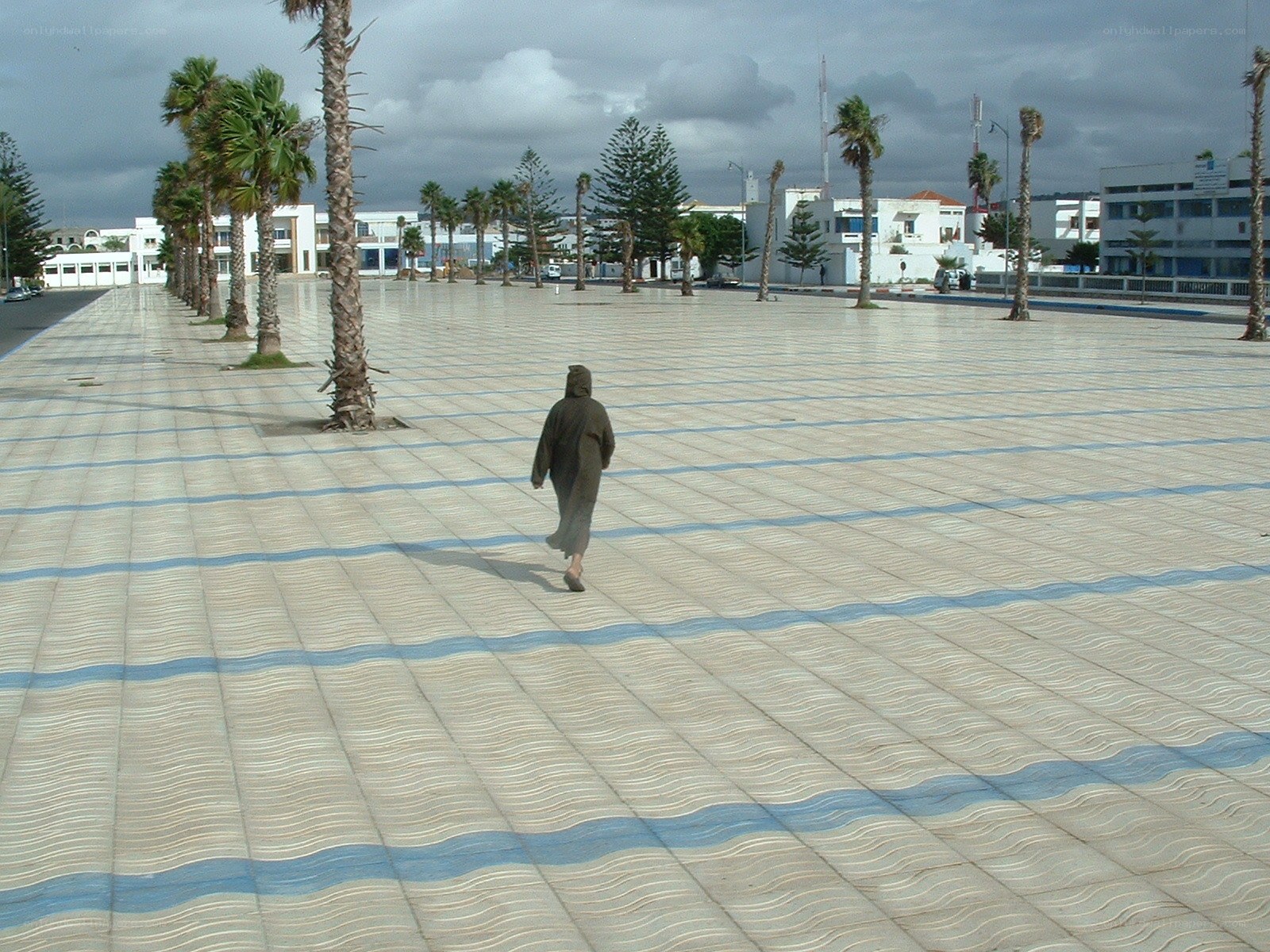 Person walking on tiled plaza