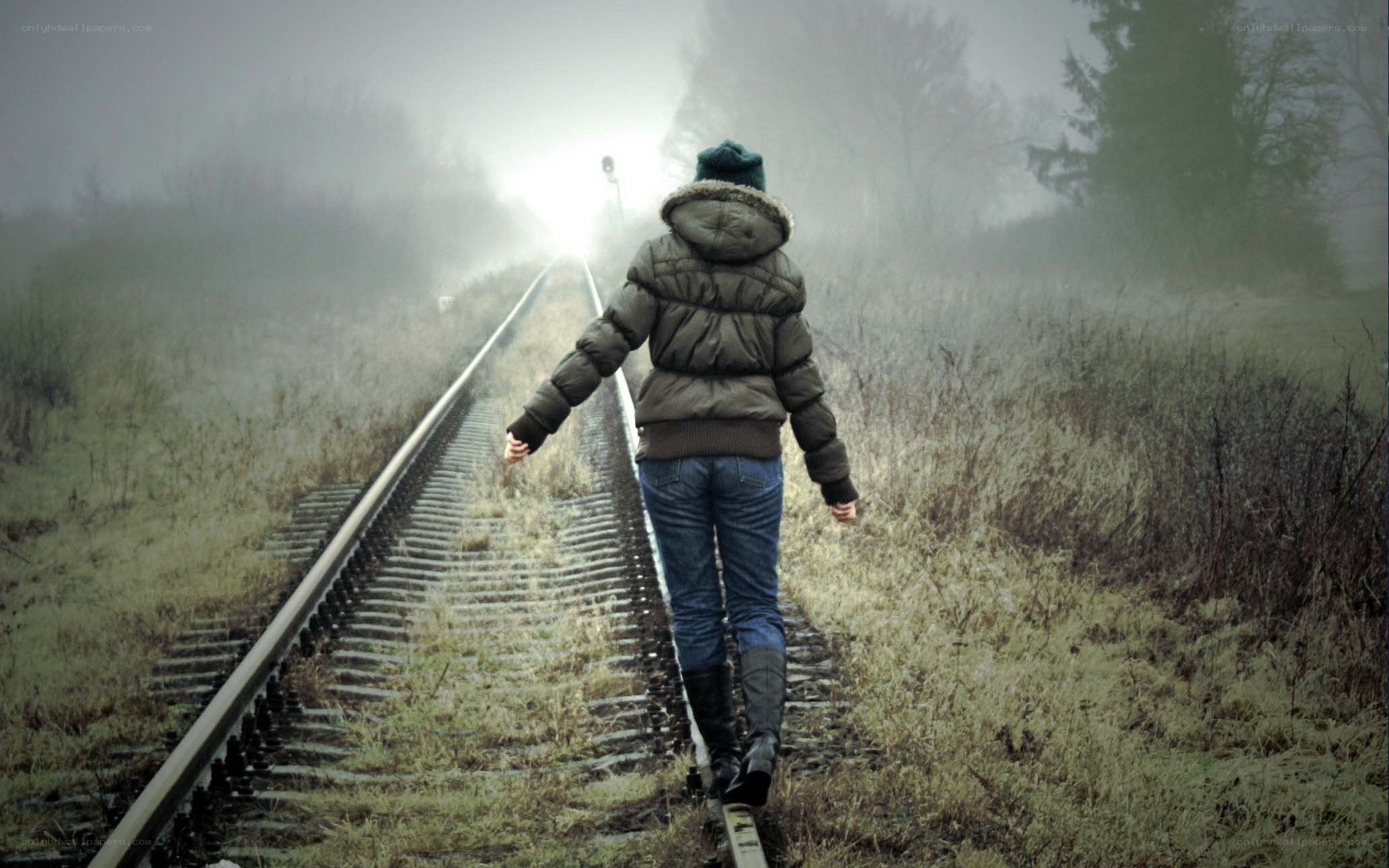 person walking on train tracks