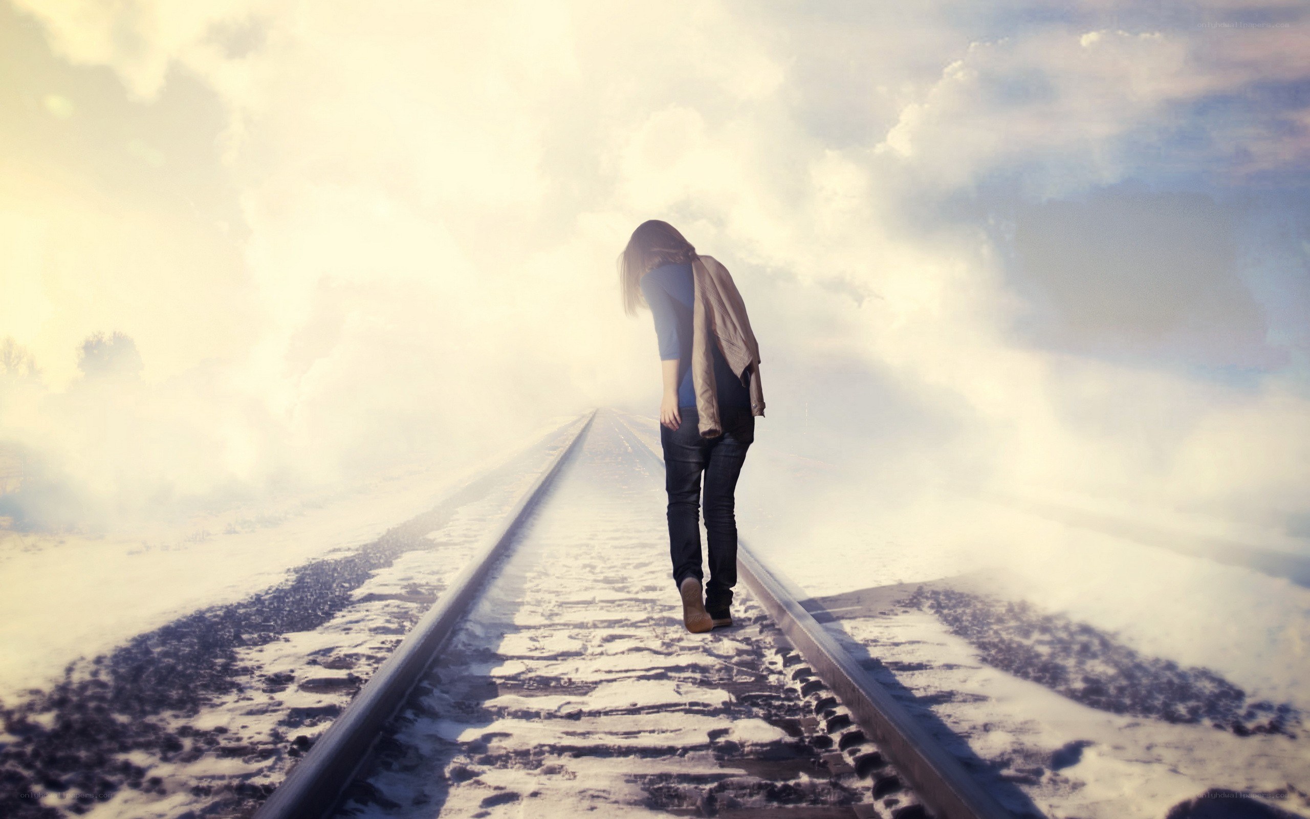 person walking on train tracks