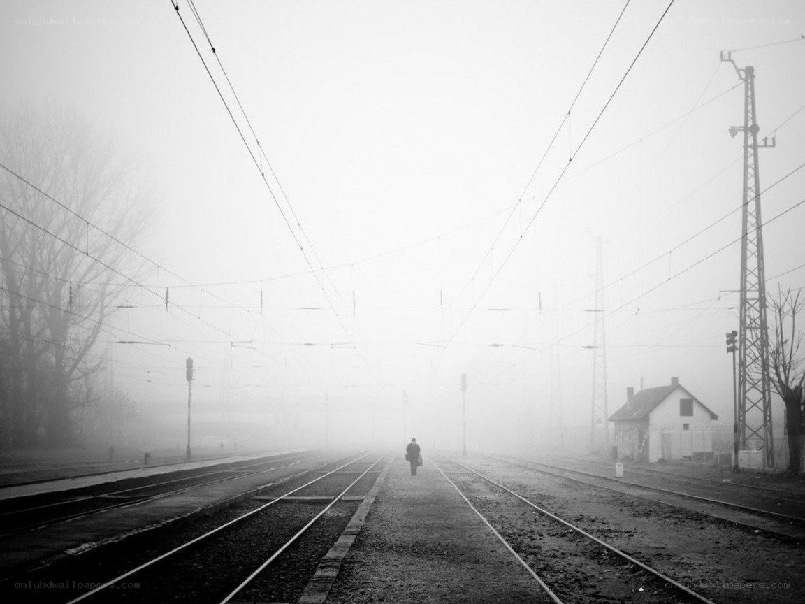 person walking on train tracks