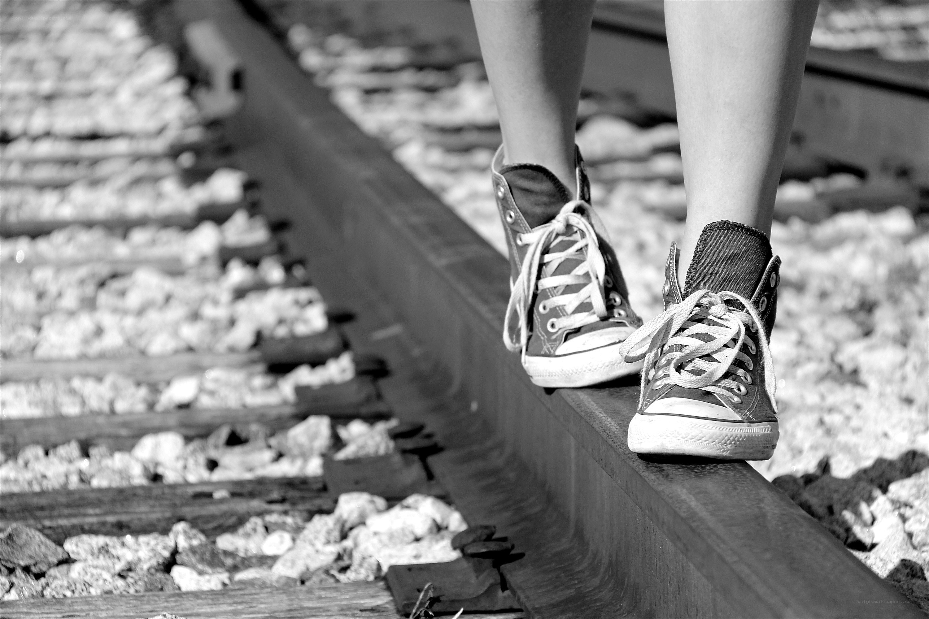 person walking on train tracks