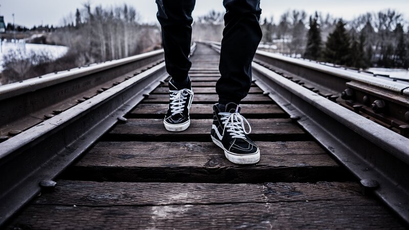 person walking on train tracks