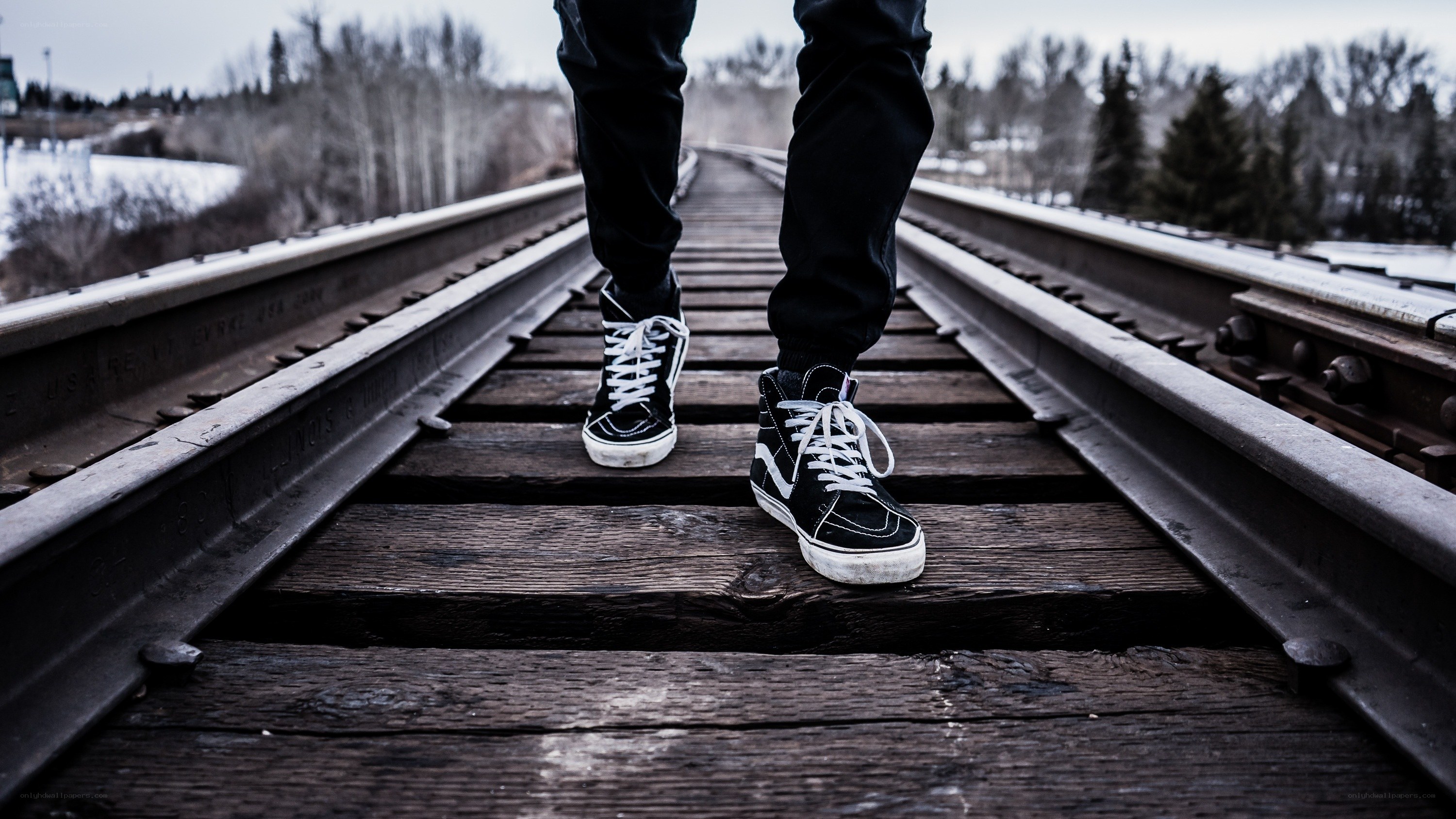 person walking on train tracks